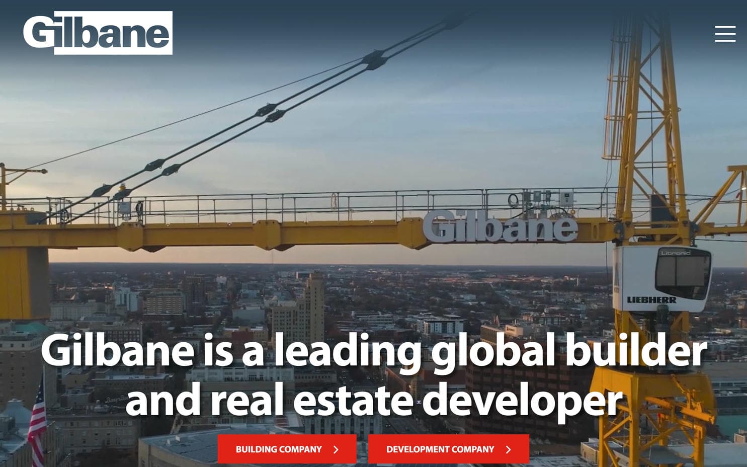 A construction crane over a city on Gilbane's construction website