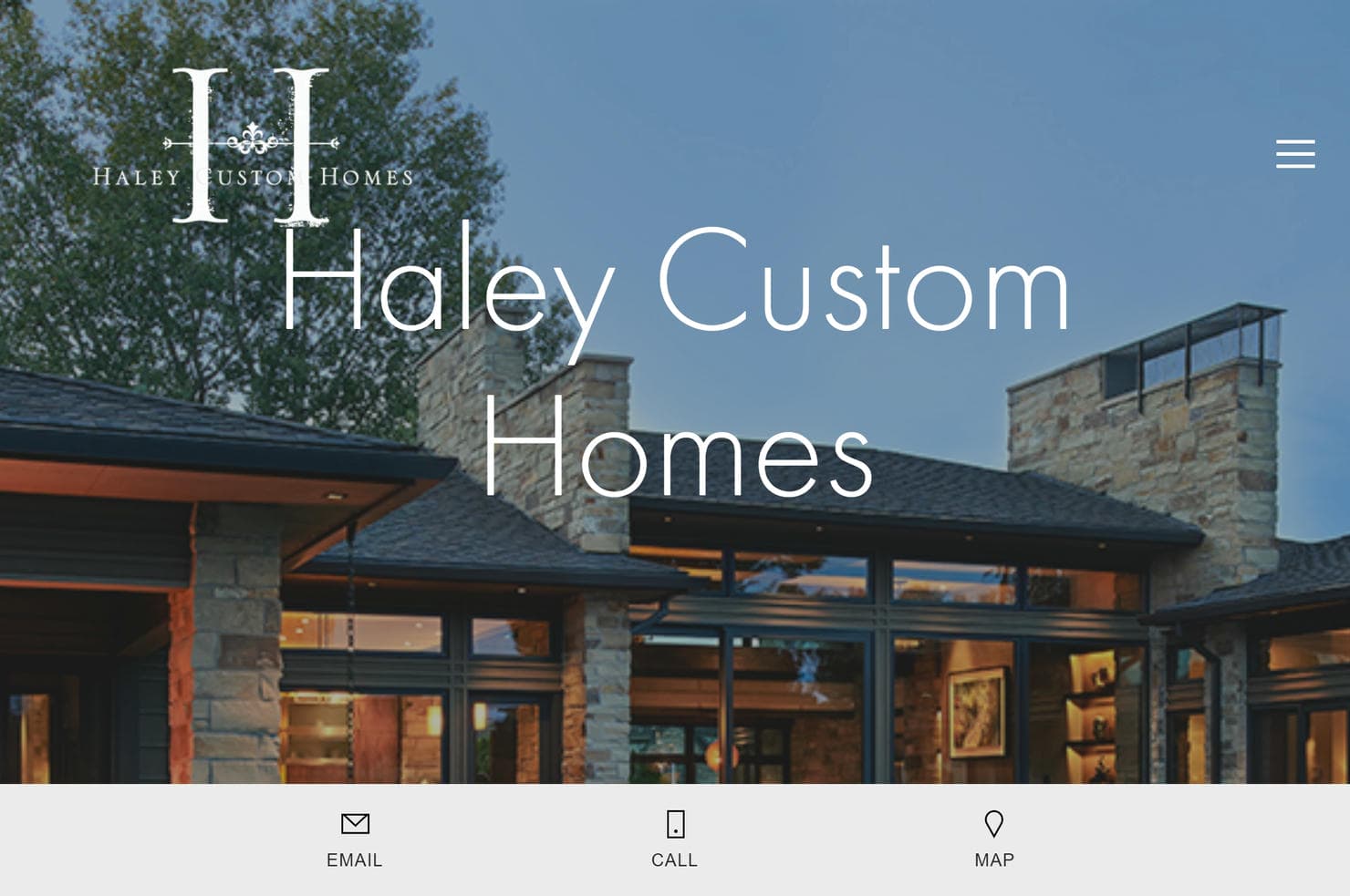 A home with stone and glass design elements on the Haley Custom Homes website