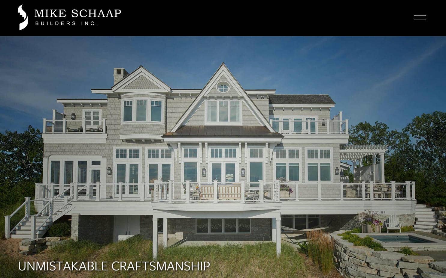 A large house with a deck on Mike Schaap Builders's website.