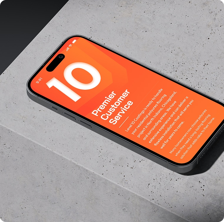 A black smartphone with an orange screen displaying "10 Premier Customer Service" rests on a gray concrete surface.