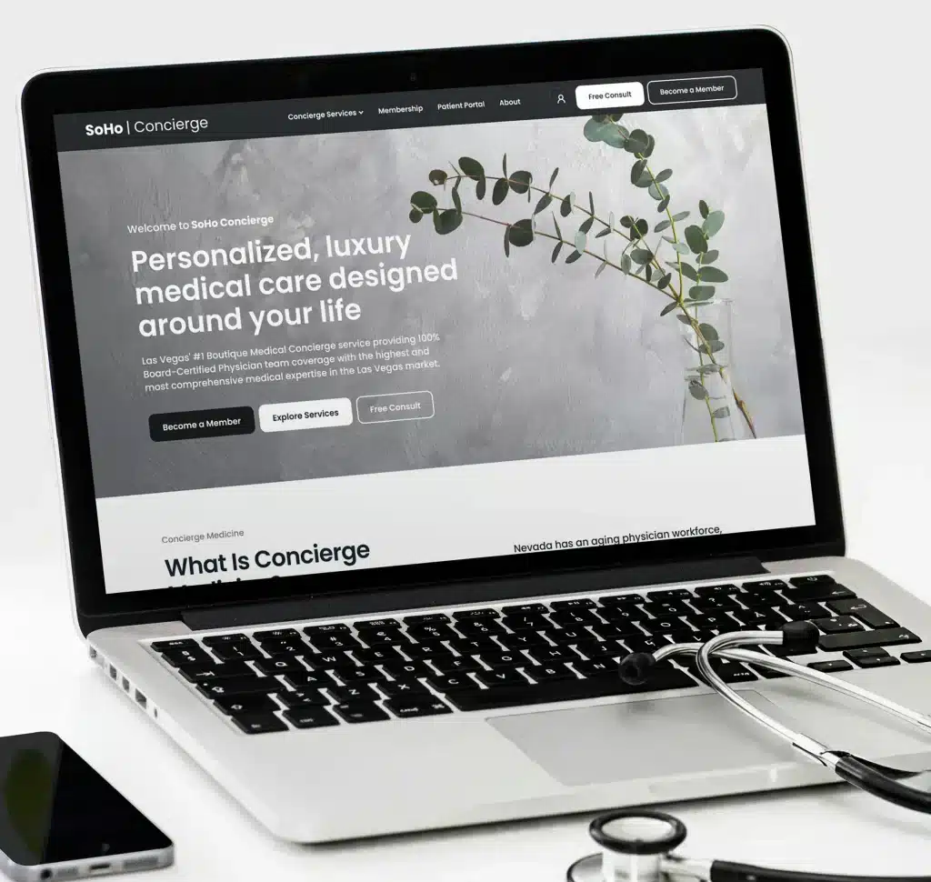 A laptop displays "SoHo Concierge" website with "Personalized, luxury medical care" and a stethoscope nearby.