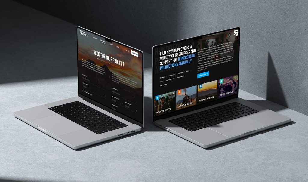 Two silver laptops display a website; the left shows "REGISTER YOUR PROJECT" and the right shows "FILM NEVADA."