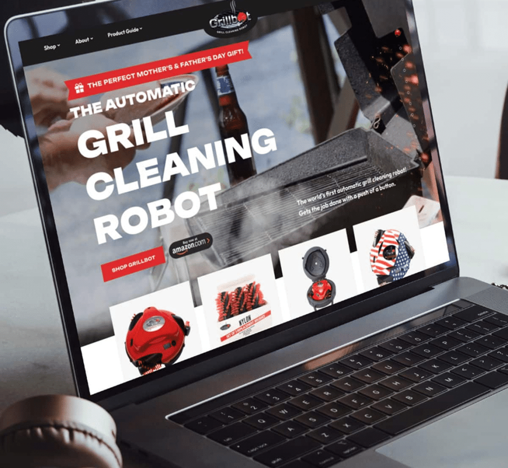 A laptop displays the "Grillbot" website with "THE AUTOMATIC GRILL CLEANING ROBOT" and product images.